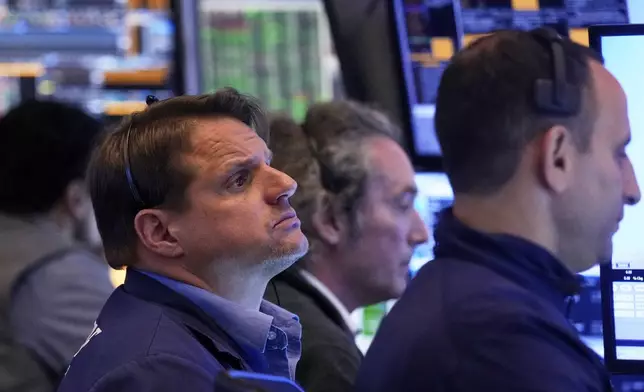 Trader Michael Milano, left, works with colleagues on the floor of the New York Stock Exchange, Tuesday, May 27, 2025. (AP Photo/Richard Drew)
