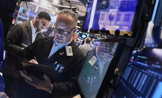 Trader Robert Arciero, right, works on the floor of the New York Stock Exchange, Tuesday, May 27, 2025. (AP Photo/Richard Drew)