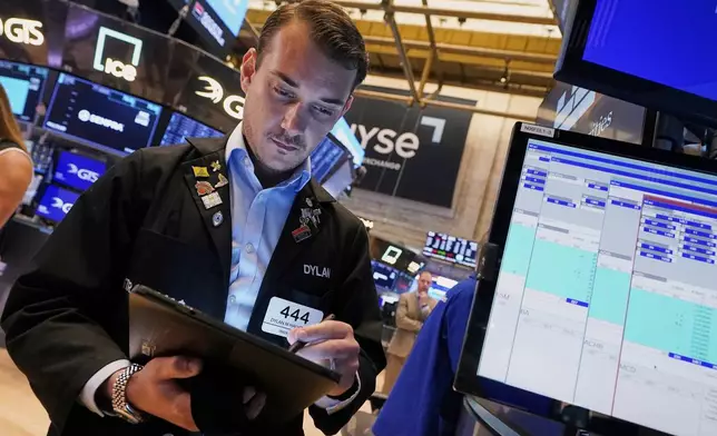 Dylan Halvorsan works on the floor of the New York Stock Exchange, Tuesday, May 27, 2025. (AP Photo/Richard Drew)