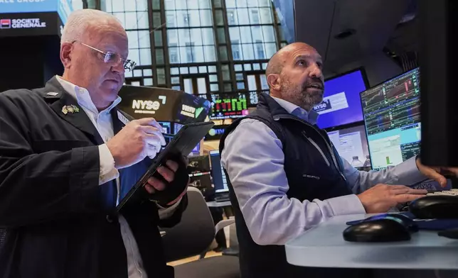 Trader Thomas Ferrigno, left, and specialist James Denaro work on the floor of the New York Stock Exchange, Tuesday, May 27, 2025. (AP Photo/Richard Drew)