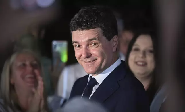 Presidential candidate Nicusor Dan smiles after polls closed in the first round of the country's presidential election redo in Bucharest, Romania, Sunday, May 4, 2025. (AP Photo/Eduard Vinatoru)