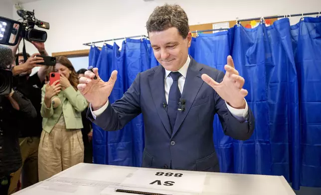 Presidential candidate Nicusor Dan reacts after casting his vote in the first round of the presidential election redo in Bucharest, Romania, Sunday, May 4, 2025. (AP Photo/Andreea Alexandru)