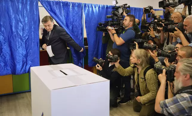 Presidential candidate Crin Antonescu exits a voting cabin before casting his vote in the first round of the presidential election redo in Bucharest, Romania, Sunday, May 4, 2025. (AP Photo/Vadim Ghirda)