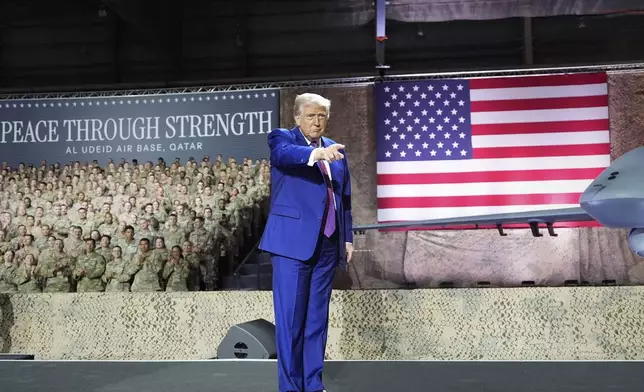 President Donald Trump gestures on stage at the Al Udeid Air Base, Thursday, May 15, 2025, in Doha, Qatar. (AP Photo/Alex Brandon)