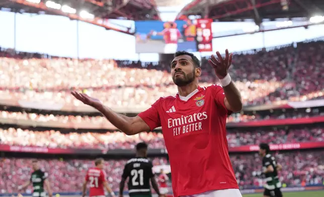 Benfica's Vangelis Pavlidis encourages fans for their support during a Portuguese league soccer match between SL Benfica and Sporting CP at the Luz stadium in Lisbon, Saturday, May 10, 2025. (AP Photo/Armando Franca)