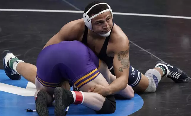 FILE - Penn State's Aaron Brooks, top, takes on Northern Iowa's Parker Keckeisen during their 184-pound match in the semifinal round of the NCAA wrestling championships March 19, 2021, in St. Louis. (AP Photo/Jeff Roberson, File)