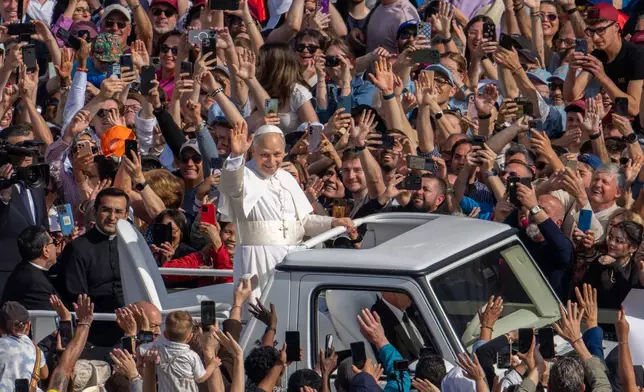Pope Leo XIV on his popemobile tours St. Peter's Square at the Vatican prior to the inaugural Mass of his pontificate, Sunday, May 18, 2025. (AP Photo/Domenico Stinellis)