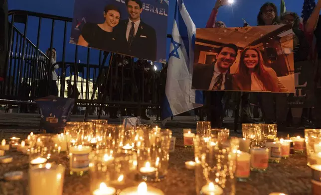 FILE - People gather to light candles in a makeshift memorial to honor Yaron Lischinsky and Sarah Milgrim who were killed as they left an event at the Capital Jewish Museum in Washington, during a candlelight vigil outside of the White House in Washington, Thursday, May 22, 2025. (AP Photo/Jose Luis Magana, file)