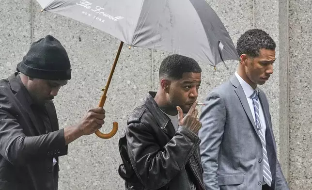 Rapper Kid Cudi, center, arrives at Federal Court for the trial of Sean "Diddy" Combs, in New York, Thursday, May 22, 2025. (AP Photo/Richard Drew)