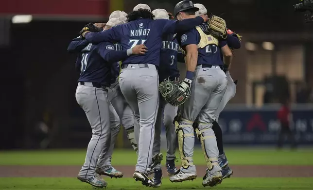 Members of the Seattle Mariners celebrate after the team defeated the San Diego Padres 4-1 in a baseball game Saturday, May 17, 2025, in San Diego. (AP Photo/Gregory Bull)