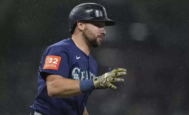 Seattle Mariners' Cal Raleigh celebrates after hitting a home run during the seventh inning of a baseball game against the San Diego Padres Saturday, May 17, 2025, in San Diego. (AP Photo/Gregory Bull)