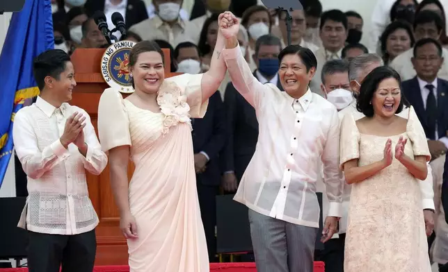 FILE - President Ferdinand Marcos Jr., center right, and Philippine Vice President Sara Duterte, daughter of former Philippine President Rodrigo Duterte, greet during the inauguration ceremony at National Museum on June 30, 2022 in Manila, Philippines. (AP Photo/Aaron Favila, file)