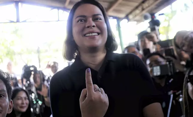Philippine Vice President Sara Duterte shows the indelible ink on her finger after casting her vote at a polling center in Davao City, southern Philippines, Monday, May 12, 2025. (AP Photo/Manman Dejeto)
