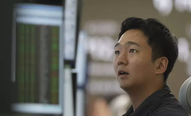 A dealer watches computer monitors at a dealing room of Hana Bank in Seoul, South Korea, Friday, May 30, 2025. (AP Photo/Lee Jin-man)