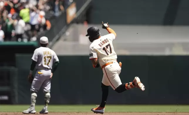 San Francisco Giants' Heliot Ramos, right, runs the bases after hitting a solo home run during the first inning of a baseball game against the Athletics, Sunday, May 18, 2025, in San Francisco. (AP Photo/Godofredo A. Vásquez)