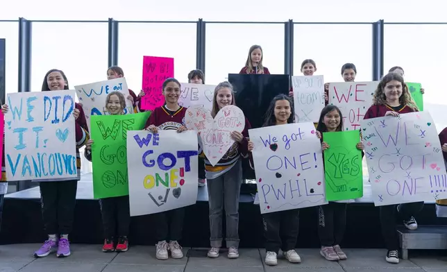 Member of the Vancouver Angels girls ice hockey team help announce that the PWHL will be expanding to Vancouver for the 2025-26 season during a press event in Vancouver, British Columbia, Wednesday April 23, 2025. (Rich Lam/The Canadian Press via AP)