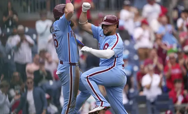 Philadelphia Phillies' Rafael Marchán, right, and Brandon Marsh celebrate after Marchán's two-run home run against Atlanta Braves pitcher AJ Smith-Shawver during the third inning in the first baseball game of a doubleheader Thursday, May 29, 2025, in Philadelphia. (AP Photo/Matt Slocum)