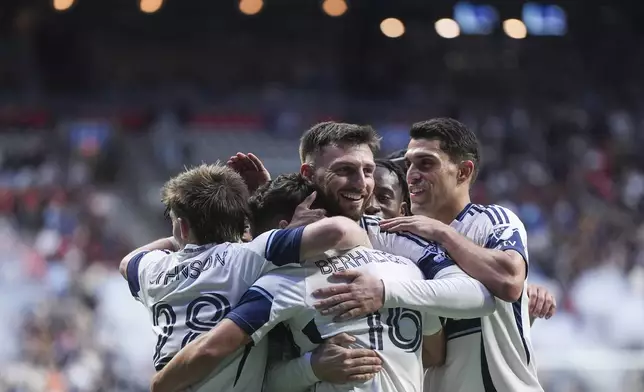 Vancouver Whitecaps' Tristan Blackmon, center, celebratesafter his goal with Tate Johnson (28), Sebastian Berhalter (16), Daniel Rios, right, and J.C. Ngando, back, during the second half of an MLS soccer match in Vancouver, British Columbia, Saturday, May 3, 2025. (Darryl Dyck/The Canadian Press via AP)