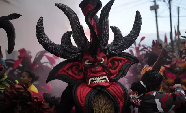 Revelers take part in the Devils and Congos Festival in Portobelo, Panama, Saturday, May 3, 2025. (AP Photo/Matias Delacroix)