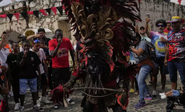 Revelers take part in the Devils and Congos Festival in Portobelo, Panama, Saturday, May 3, 2025. (AP Photo/Matias Delacroix)