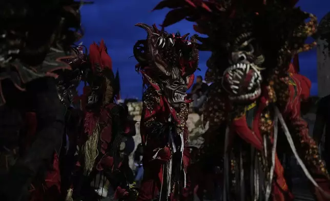 Revelers take part in the Devils and Congos Festival in Portobelo, Panama, Saturday, May 3, 2025. (AP Photo/Matias Delacroix)