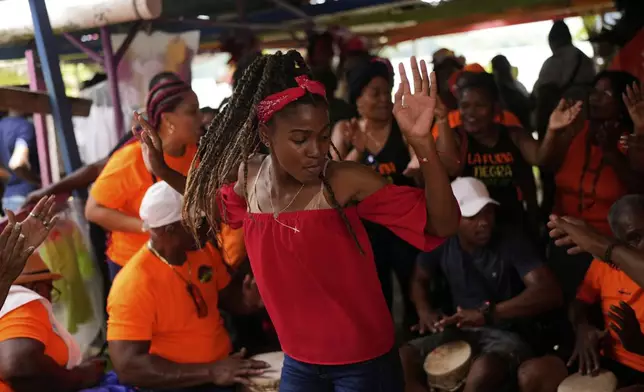 A woman dances during the Devils and Congos Festival in Portobelo, Panama, Saturday, May 3, 2025. (AP Photo/Matias Delacroix)