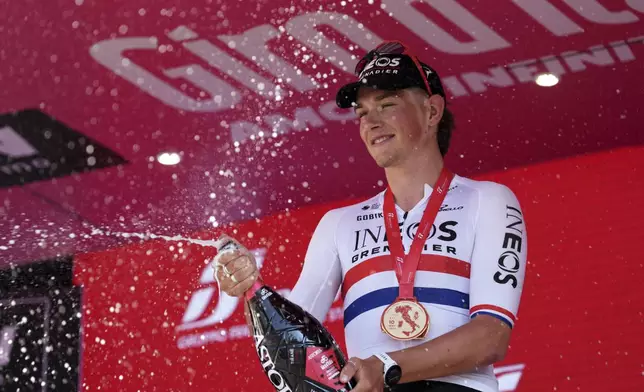 Britain's Josh Tarling celebrates winning the time trial stage 2 of the Giro d'Italia cycling race, in Tirana, Albania, Saturday, May 10, 2025. (Massimo Paolone/LaPresse via AP)