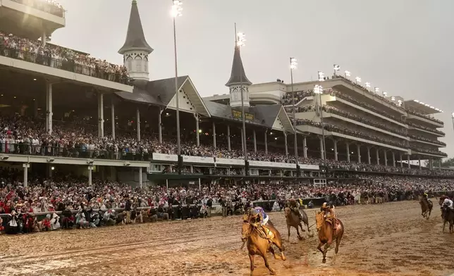 Sovereignty, left, ridden by Junior Alvarado, crosses the finish line to win the 151st running of the Kentucky Derby horse race at Churchill Downs Saturday, May 3, 2025, in Louisville, Ky. (AP Photo/Abbie Parr)
