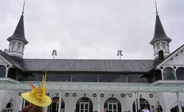 Race fans walk though the grounds at Churchill Downs before the 151st running of the Kentucky Derby horse race Saturday, May 3, 2025, in Louisville, Ky. (AP Photo/Brynn Anderson)