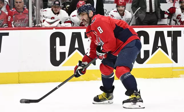 Washington Capitals left wing Alex Ovechkin (8) skates with the puck in the first period of Game 5 of a second-round NHL hockey playoff series against the Carolina Hurricanes Thursday, May 15, 2025, in Washington. (AP Photo/Nick Wass)