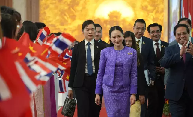 Thai Prime Minister Paetongtarn Shinawatra, front center, walks to a meeting in Hanoi, Vietnam Friday, May 16, 2025. (AP Photo/Hau Dinh)