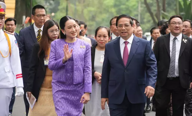 Vietnamese Prime Minister Pham Minh Chinh, front right, and Thai Prime Minister Paetongtarn Shinawatra, front left, walk to a meeting in Hanoi, Vietnam Friday, May 16, 2025. (AP Photo/Hau Dinh)