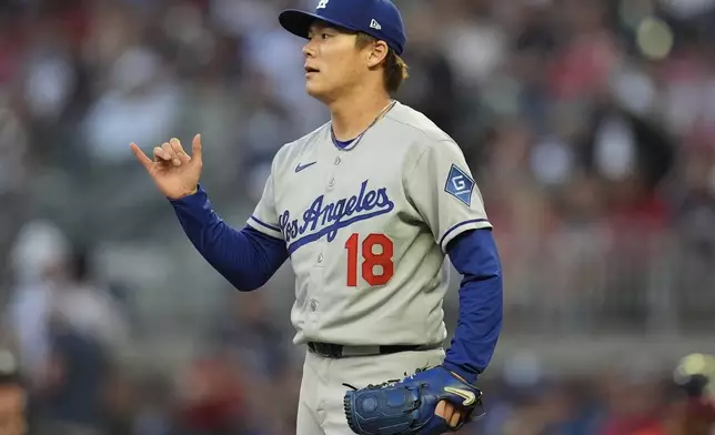 Los Angeles Dodgers pitcher Yoshinobu Yamamoto (18) reacts in the fourth inning of a baseball game against the Atlanta Braves, Friday, May 2, 2025, in Atlanta. (AP Photo/Mike Stewart)