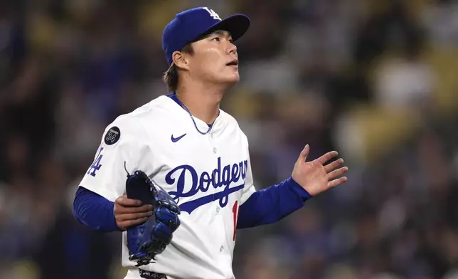 Los Angeles Dodgers starting pitcher Yoshinobu Yamamoto gestures after a double play ended the top of the third inning of a baseball game against the Pittsburgh Pirates, Friday, April 25, 2025, in Los Angeles. (AP Photo/Mark J. Terrill)