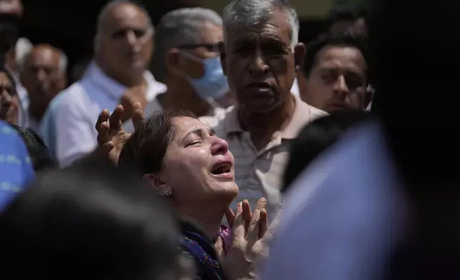 A relative mourns at the funeral of Raj Thapa, a senior bureaucrat who was killed in Pakistani shelling in Rajouri, in Jammu, India, Sunday, May 11, 2025. (AP Photo/Channi Anand)