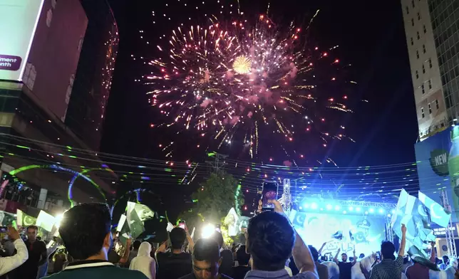 People watch fireworks during an event to show solidarity with the Pakistan Army, a day after the ceasefire between Indian and Pakistan was announced, in Lahore, Pakistan, Sunday, May 11, 2025. (AP Photo/K.M. Chaudary)