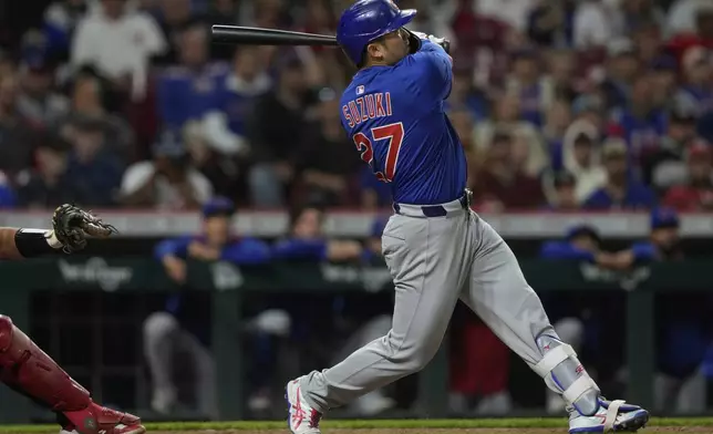 Chicago Cubs' Seiya Suzuki watches his three-run home run in the eighth inning of a baseball game against the Cincinnati Reds, Friday, May 23, 2025, in Cincinnati. (AP Photo/Carolyn Kaster)