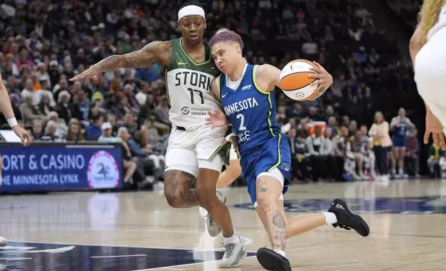 Minnesota Lynx guard Natisha Hiedeman (2) works toward the basket as Seattle Storm guard Erica Wheeler (17) defends during the first half of a WNBA basketball game Tuesday, May 27, 2025, in Minneapolis. (AP Photo/Abbie Parr)