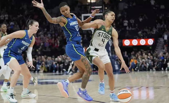 Seattle Storm guard Skylar Diggins (4) works toward the basket as Minnesota Lynx guard Courtney Williams (10) defends during the second half of a WNBA basketball game Tuesday, May 27, 2025, in Minneapolis. (AP Photo/Abbie Parr)