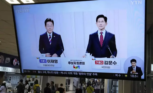 FILE - A TV screen shows the People Power Party's presidential candidate Kim Moon Soo, right, and the Democratic Party's presidential candidate Lee Jae-myung during a presidential debate for the upcoming June 3 presidential election, at a bus terminal in Seoul, South Korea, on May 27, 2025. (AP Photo/Ahn Young-joon, File)
