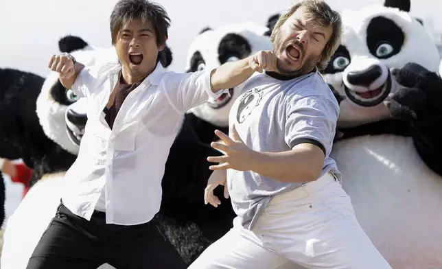 FILE - Actors Jack Black, right, and Tatsuya Yamaguchi participate in a stunt on the Carlton beach pier for the film "Kung Fu Panda" during the 61st Cannes International Film Festival in Cannes, southern France, Wednesday, May 14, 2008. (AP Photo/Matt Sayles, File)