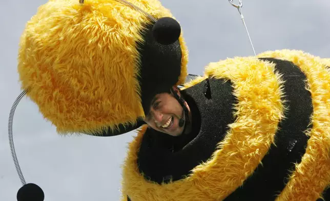 FILE - American comedian Jerry Seinfeld glides through the air connected to a wire during a publicity stunt for the film "Bee Movie," at the 60th International film festival in Cannes, southern France, on Thursday, May 17, 2007. (AP Photo/Andrew Medichini, File)
