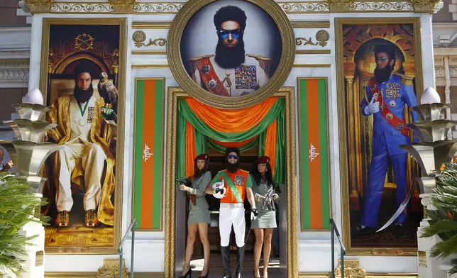 FILE - Actor Sacha Baron Cohen, center, poses as he arrives for a photo call for The Dictator at the 65th international film festival, in Cannes, southern France, Wednesday, May 16, 2012. (AP Photo/Francois Mori, File)