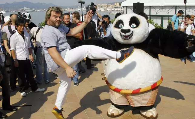 FILE - Actor Jack Black, centre, and Tatsuya Yamaguchi, left, participate in a stunt on the Carlton beach pier for the film "Kung Fu Panda" during the 61st Cannes International Film Festival in Cannes, southern France, Wednesday, May 14, 2008. (AP Photo/Francois Mori, File)