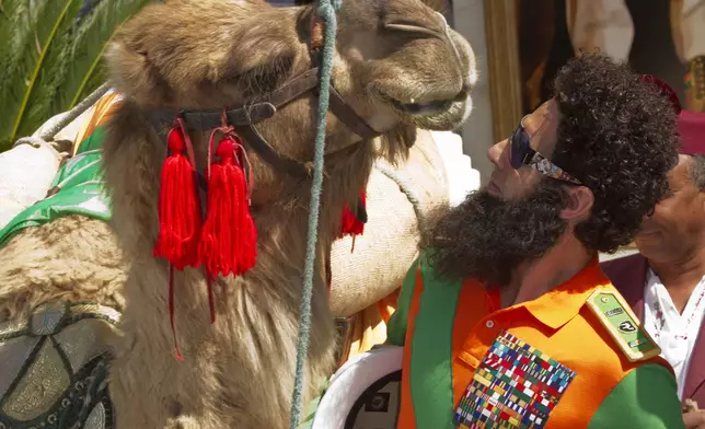 FILE - Actor Sacha Baron Cohen poses with a a camel during a photo call for The Dictator at the 65th international film festival, in Cannes, southern France, Wednesday, May 16, 2012. (AP Photo/Joel Ryan, File)