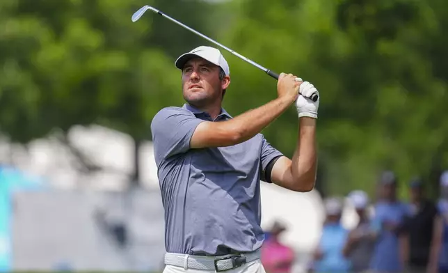 Scottie Scheffler hits a shot on the first hole fairway during the final round of the Charles Schwab Challenge golf tournament at Colonial Country Club in Fort Worth, Texas, Sunday, May 25, 2025. (AP Photo/LM Otero)