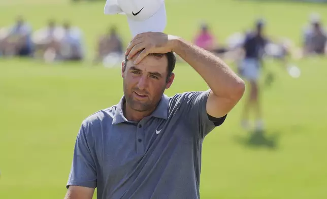 Scottie Scheffler reacts after finishing on the 18th hole during the final round of the Charles Schwab Challenge golf tournament at Colonial Country Club in Fort Worth, Texas, Sunday, May 25, 2025. (AP Photo/LM Otero)
