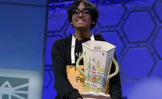 Faizan Zaki, 13, of Dallas, holds the trophy after winning the 2025 Scripps National Spelling Bee at the Gaylord National Resort &amp; Convention Center Thursday, May 29, 2025, in Oxon Hill, Md. (AP Photo/Jose Luis Magana)