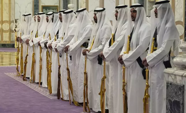 Members of a traditional Saudi honor guard with their golden swords wait for the arrival of President Donald Trump and Saudi Crown Prince Mohammed bin Salman during an arrival ceremony at the Royal Palace in Riyadh, Saudi Arabia, Tuesday, May 13, 2025. (AP Photo/Alex Brandon)