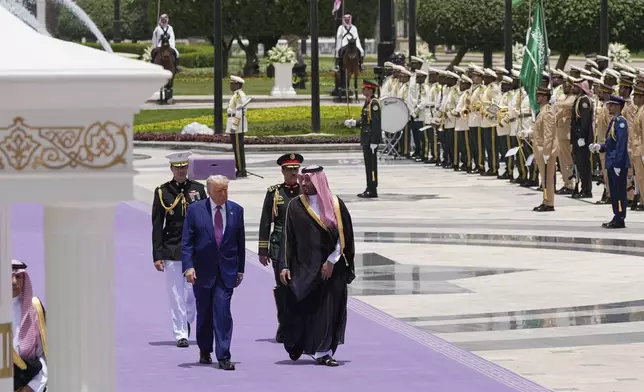 President Donald Trump and Saudi Crown Prince Mohammed bin Salman walk during an arrival ceremony at the Royal Palace in Riyadh, Saudi Arabia, Tuesday, May 13, 2025. (AP Photo/Alex Brandon)